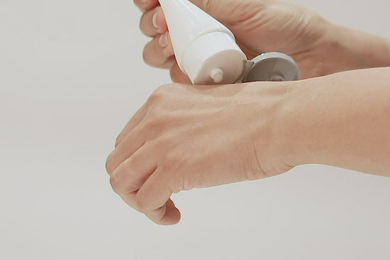 Woman applying IOPE Pro Peeling Soft Gel to hand before rinsing